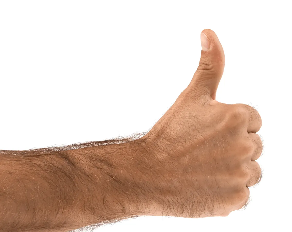 Close-up of a person’s hand giving a thumbs up gesture, isolated on a white background.